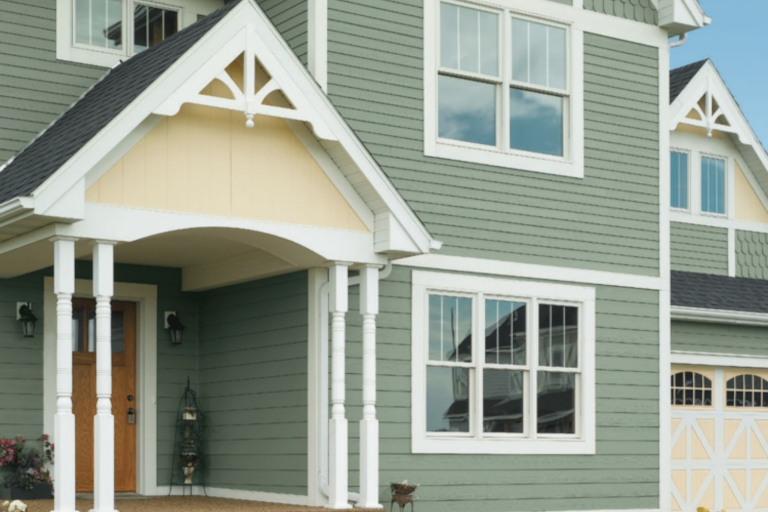 Modern home with green fiber cement siding and white trim